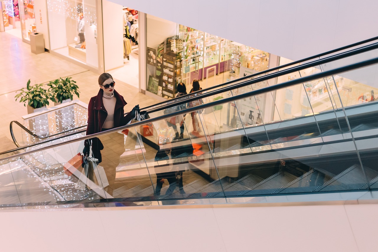 Girl on escalator in shopping mall