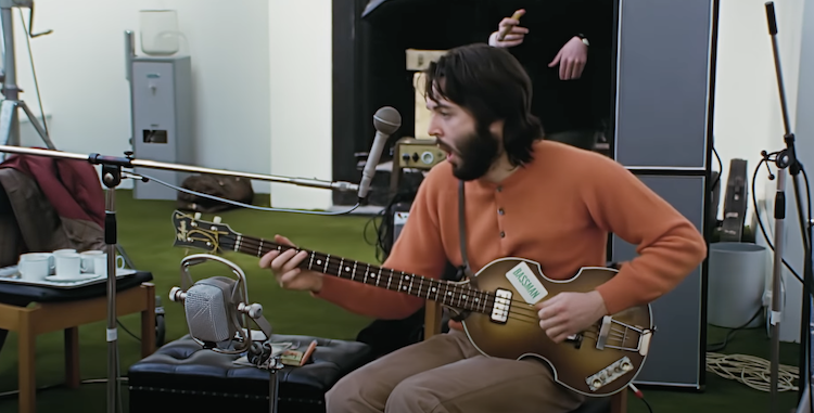 Paul McCartney plays guitar in studio