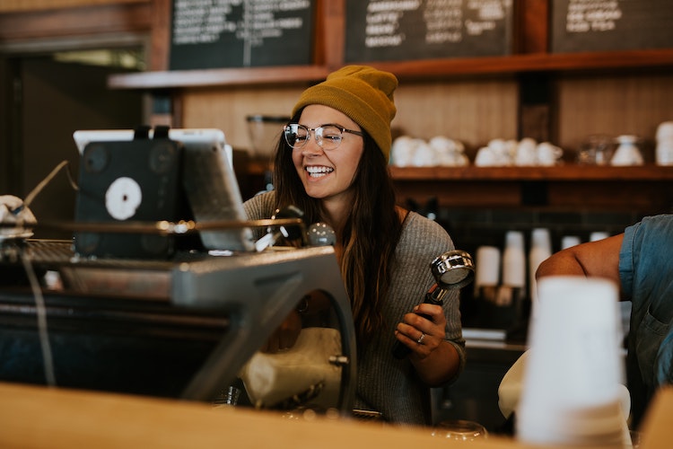 Woman in a hat serving in coffee shop