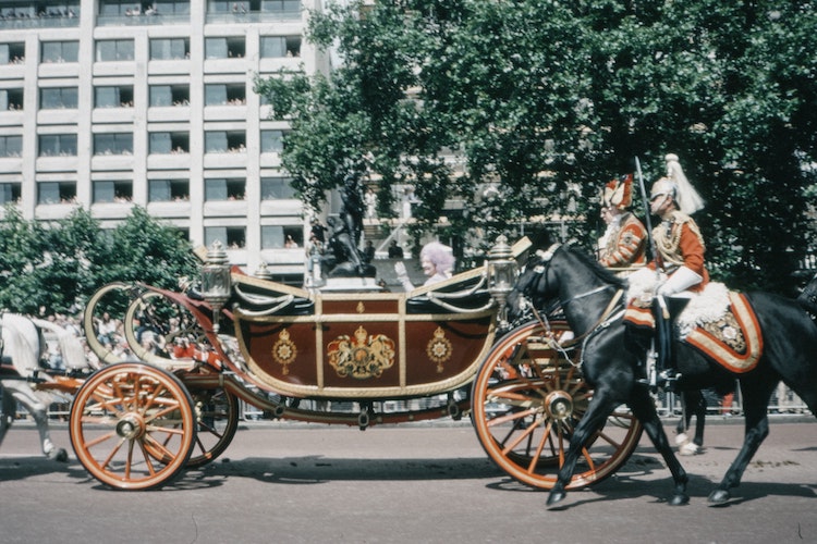 Queen riding in gold carriage in London in 1960s