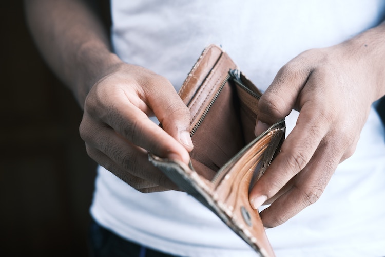 Man opens empty wallet